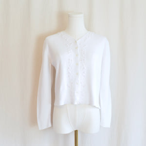 white cotton blend with embroidered floral detail